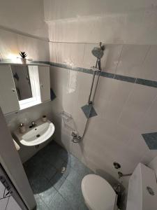 a bathroom with a toilet and a sink at Valente Rooms Kythira in Kythira