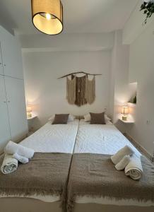 a bedroom with a large bed with towels on it at Valente Rooms Kythira in Kythira