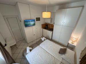 a small room with a bed and a kitchen at Valente Rooms Kythira in Kythira