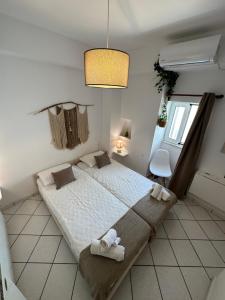 a bedroom with a large bed with towels on it at Valente Rooms Kythira in Kythira