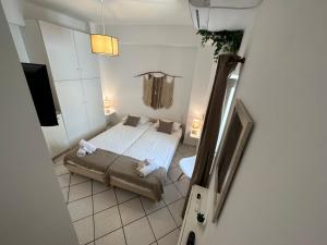 a bedroom with a bed and a tv in a room at Valente Rooms Kythira in Kythira