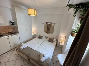 a small bedroom with a bed with towels on it at Valente Rooms Kythira in Kythira