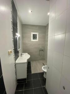 a bathroom with a sink and a toilet at Les jardins in Tunis