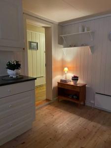 una cocina con una mesa y una lámpara en una mesa en Koselig gammelt hus på gård 
