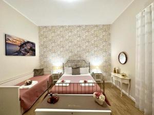 a bedroom with a large bed and two tables at Olympus Pompei Rooms in Pompei