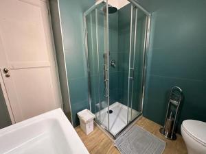 a bathroom with a shower with a sink and a toilet at Home Pompei Olympus in Pompei +56 photos