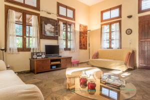 a living room with a couch and a table at CalmNature in Agnontas