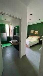 a bedroom with a bed and a sink and a mirror at Liu' al viale in Agrigento