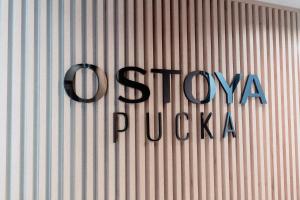 a sign on the side of a building with the words show pucka at Marinero Apartament in Puck