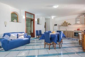 a living room with a blue couch and a table at Villa Lena in Conca dei Marini