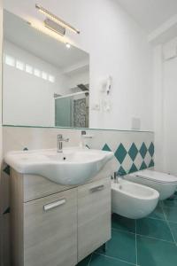 a bathroom with a sink and a toilet at Villa Lena in Conca dei Marini