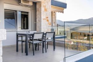 a black table and chairs on a balcony at ONITES Elegant Suites in Skala Potamias