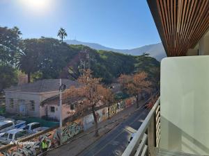 a balcony with a view of a street with cars at Departamento - Salta Capital ae - Edificio Usina in Salta +21 photos