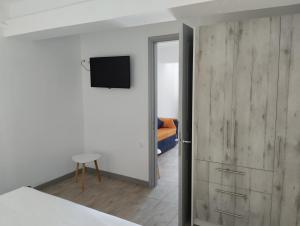 a bedroom with a bed and a sliding wooden door at el castle in Agioi Apostoli