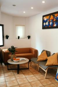 a living room with a couch and a table at LOFT APART & HOSTAL Group in Lloret de Mar