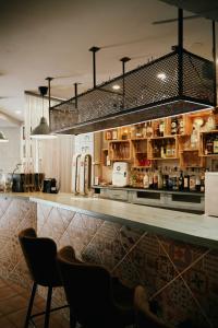 a bar with a counter with chairs in a restaurant at LOFT APART & HOSTAL Group in Lloret de Mar