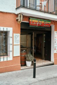 a store front of a building with plants in the doorway at LOFT APART & HOSTAL Group in Lloret de Mar