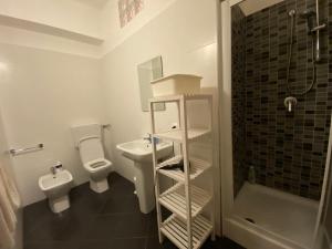 a bathroom with a toilet and a sink and a shower at Sea View - Beautiful Private Terrace with BBQ in Triscina