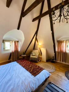 a bedroom with a large bed in a attic at Inside, The Village- Rooster's Nest 