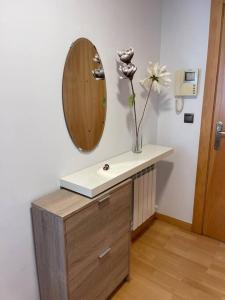 a bathroom with a sink and a mirror on the wall at Ostende Beach View apartment in Castro-Urdiales