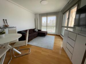 a living room with a couch and a table at Ostende Beach View apartment in Castro-Urdiales