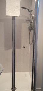 a shower stall in a bathroom with a towel at Granite City Guest House in Aberdeen