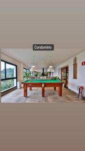 a living room with a pool table in the middle at Carpe Diem Boutique & Spa in Campos do Jordão