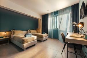 a hotel room with a bed and a desk and a desk at Luna Nova Rooms in San Valentino Torio