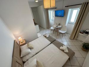 a bedroom with a bed and a table in a room at Valente Rooms Kythira in Kythira