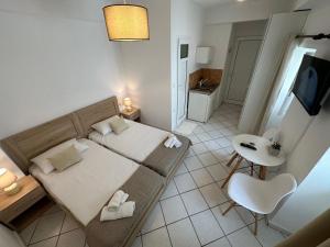 a small bedroom with a bed and a bathroom at Valente Rooms Kythira in Kythira