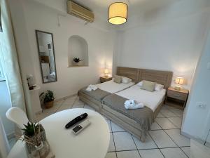 a small bedroom with a bed and a table at Valente Rooms Kythira in Kythira
