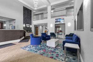 a waiting room with blue chairs and a counter at Quality Inn & Suites in Grimsby