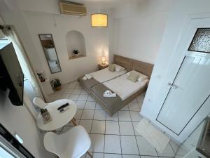 a small bedroom with a bed and a mirror at Valente Rooms Kythira in Kythira