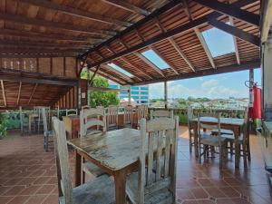 a wooden table and chairs on a patio at Hostel Manaus in Manaus