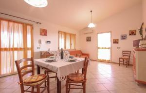 a dining room with a table and some chairs at Casa Vacanze Giovanna in SantʼAnna Arresi