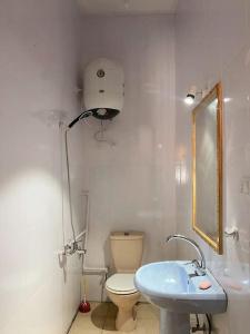 a white bathroom with a toilet and a sink at Cozy apt ‘Lemuna’ second line Assala beach in Dahab +18 photos