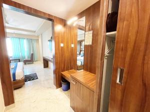 a room with a mirror and a room with a bedroom at Hotel Ambika Palace ! Puri in Puri