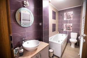 a bathroom with a sink and a tub and a toilet at Camarad’s house - lovely apartment in Alba Iulia in Alba Iulia +35 photos