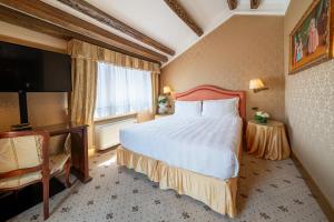 a hotel room with a large bed and a television at Hotel Colombina in Venice