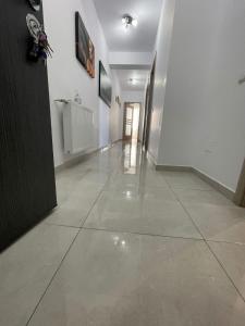 a hallway with white walls and a tile floor at HOME NAS Bragadiru in Bragadiru