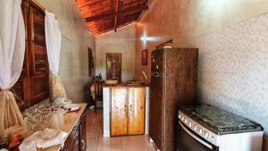 a kitchen with a refrigerator and a counter in it at Casa Barra Jucá - Barra Grande Piauí in Barra Grande