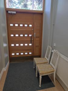 a room with two chairs and a door with a window at Apartment Upseeritie in Kouvola