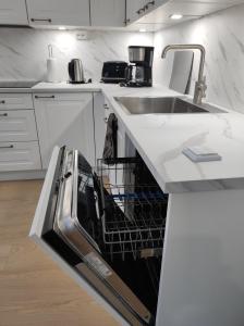 a dishwasher in a kitchen with a sink at Apartment Upseeritie in Kouvola