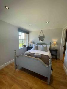 a bedroom with a bed and a window at The Coach House in Shootend