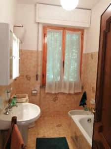 uma casa de banho com um lavatório, uma banheira e um WC. em Villa Miranda em Santa Fiora