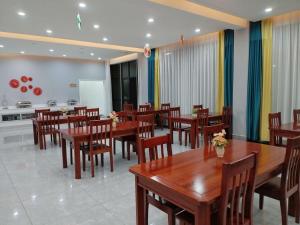 a dining room with wooden tables and chairs at Dingxiangju Hotel in Chingola