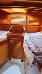 a boat with two beds in the back of it at Voilier de charme en acajou. in Ouistreham
