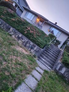 a house with stairs in front of a house at Economical Homestay in Burnaby
