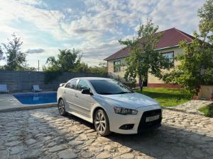 a white car parked in front of a house at Vandam Luminous Villa in Gabala