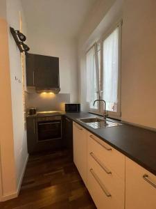 a kitchen with a black counter top and a sink at casa boutique in Ivrea